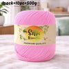 Pink silk bamboo blend yarn skein with a label indicating premium quality