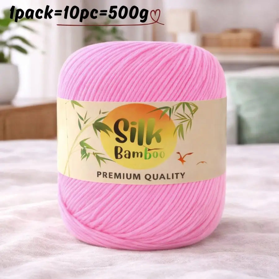 Pink silk bamboo blend yarn skein with a label indicating premium quality