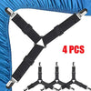 Four black adjustable bed sheet holder clips with silver ends shown against a blue fabric background.