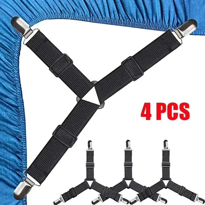 Four black adjustable bed sheet holder clips with silver ends shown against a blue fabric background.