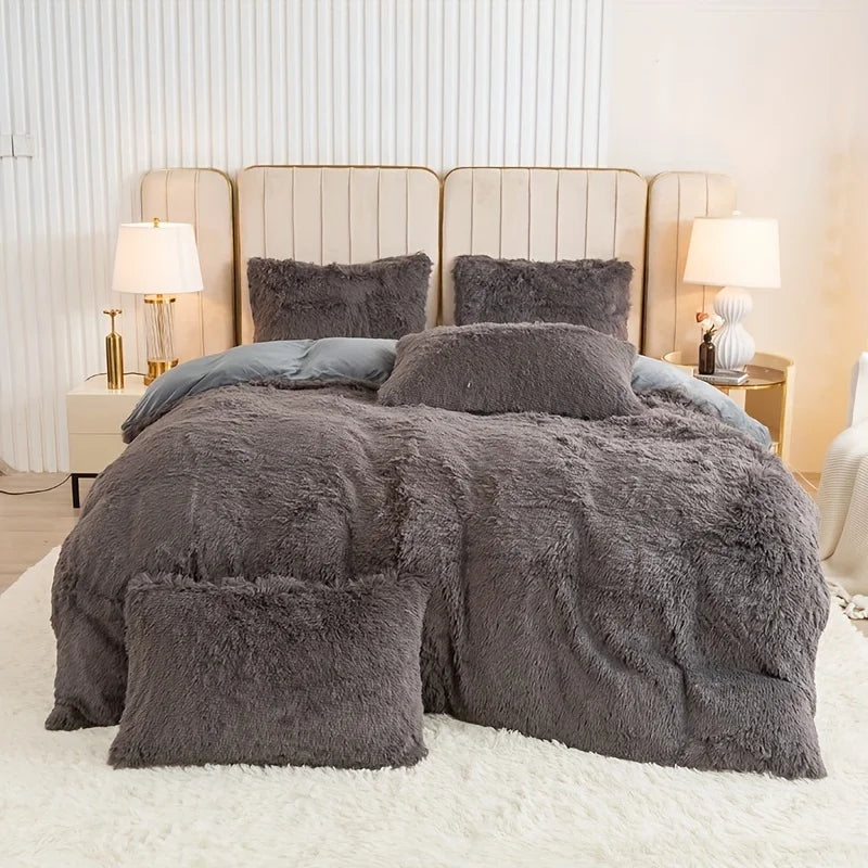 A plush gray faux fur duvet cover set displayed on a bed with upholstered headboards and bedside lamps.
