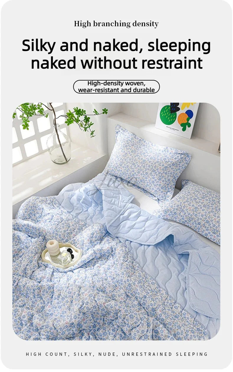 A light blue quilted bedding set featuring a delicate floral pattern, designed for silky and naked, unrestrained sleeping.