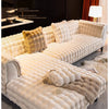 A cream colored plush velvet sofa cover with a quilted texture and light fur throw displayed in a modern interior.