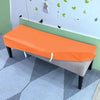 An orange stretch pu leather waterproof bench slipcover placed on a light gray floor.