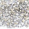 A pile of clear and gold glass rhinestones for DIY crafts