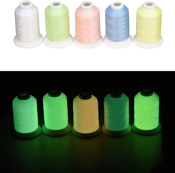 A row of glow in the dark embroidery threads in white, light green, pink, blue, and yellow.