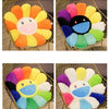 A set of cozy sunflower plush cushions featuring various pastel colors and a smiling face design.