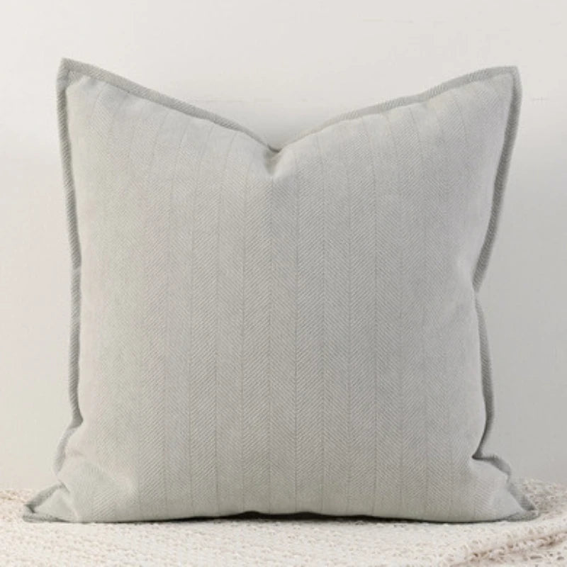 A square, light gray linen throw pillow cover with vertical stripes on a white background.