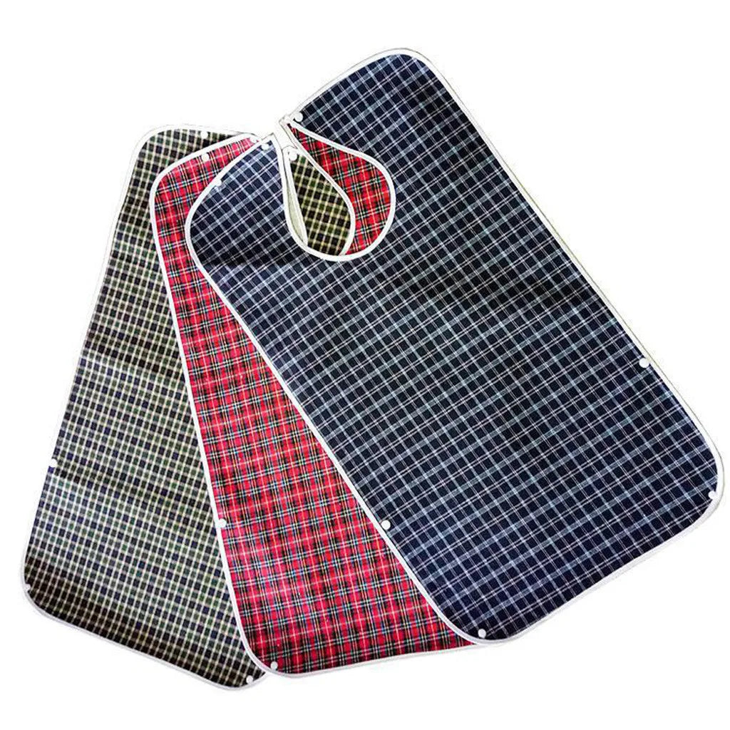 A stack of plaid waterproof mealtime bibs in navy blue and red checkered patterns.
