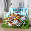 A colorful Paw Patrol themed flannel throw blanket featuring cartoon dogs in various poses.