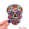 Embroidery patch of a stylized rose skull design in black and colorful thread