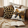 A decorative pillow cover with a leopard print and a black bow on a beige sofa.