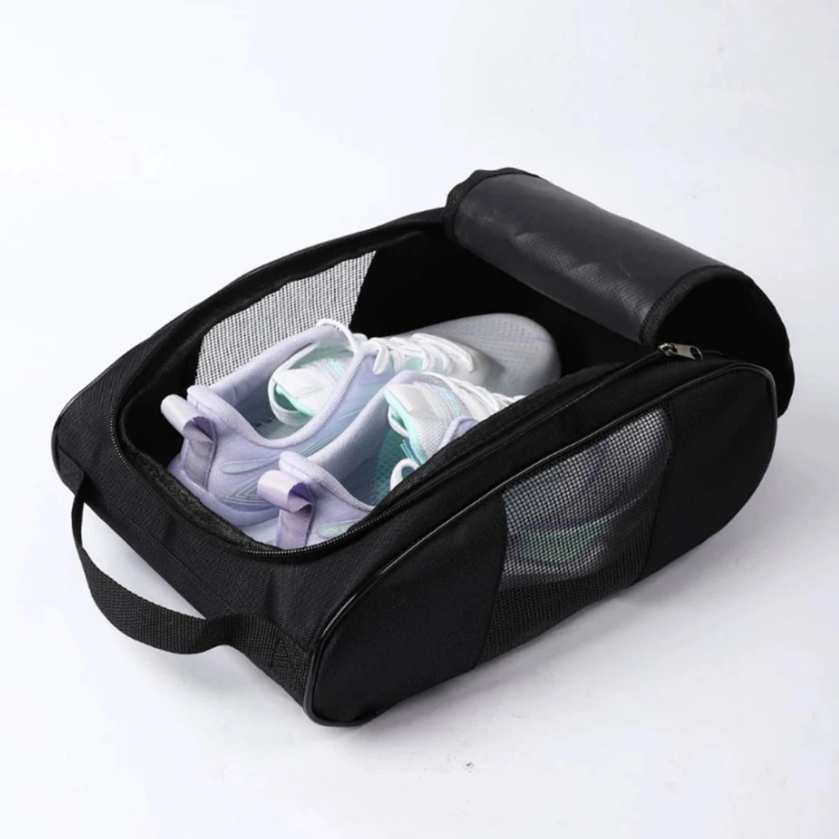 Black shoe carrier bag with a padded lid holding a pair of light-colored athletic shoes.
