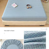 A light blue checkered fitted sheet is displayed on a bed, with fabric swatches showing its texture and drape.