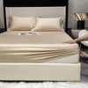 A beige luxury Egyptian cotton fitted sheet and pillow set displayed on a bed with white bedding.
