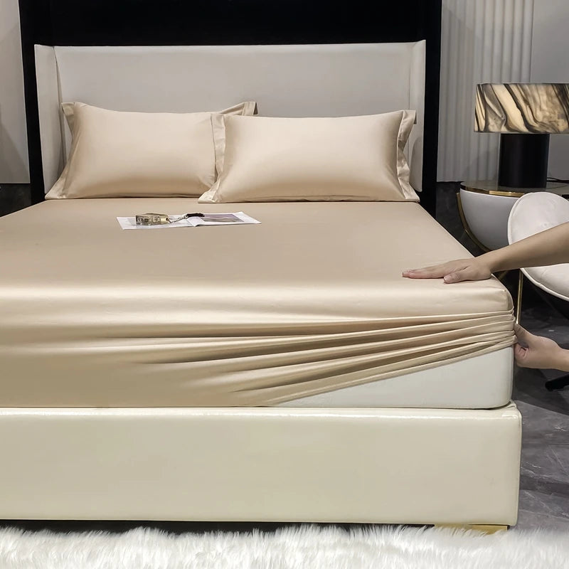 A beige luxury Egyptian cotton fitted sheet and pillow set displayed on a bed with white bedding.