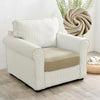 A cream upholstered armchair with vertical stripes and a beige seat cushion sits next to a large green plant.