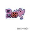 Pink and black embroidered patch featuring a letter B and a carved pumpkin design