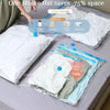 Vacuum compression storage bags showing various clothing items like jackets and sweaters being stored in clear plastic bags