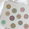 A collection of colorful mandala graffiti stickers on a light gray surface.