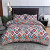 A patterned boho geometric duvet cover set featuring intricate diamond and chevron designs in purple, teal, white, and orange