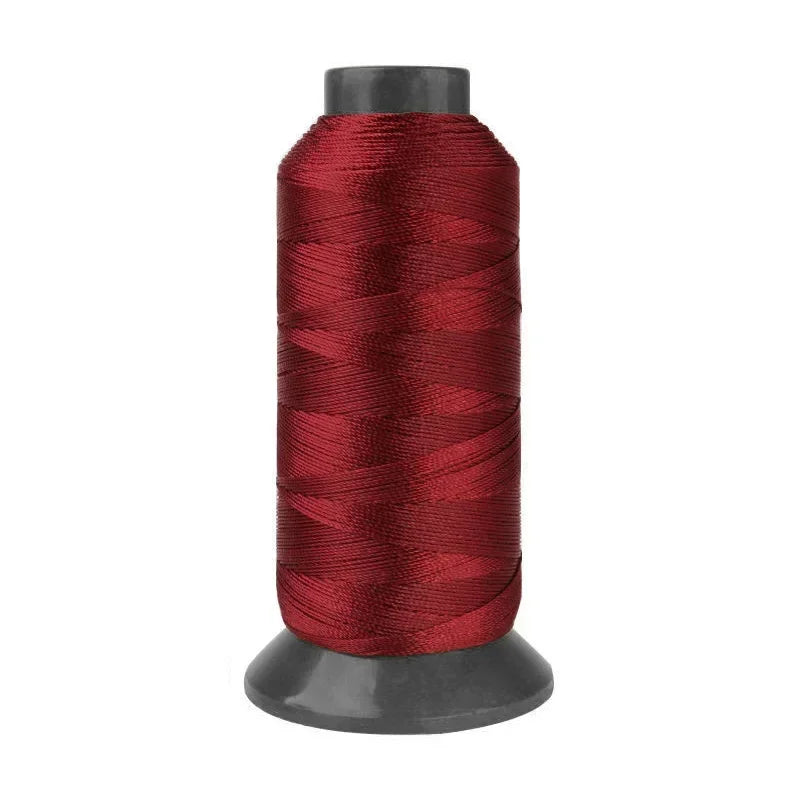 Roll of heavy duty 3-ply nylon sewing thread in deep red color