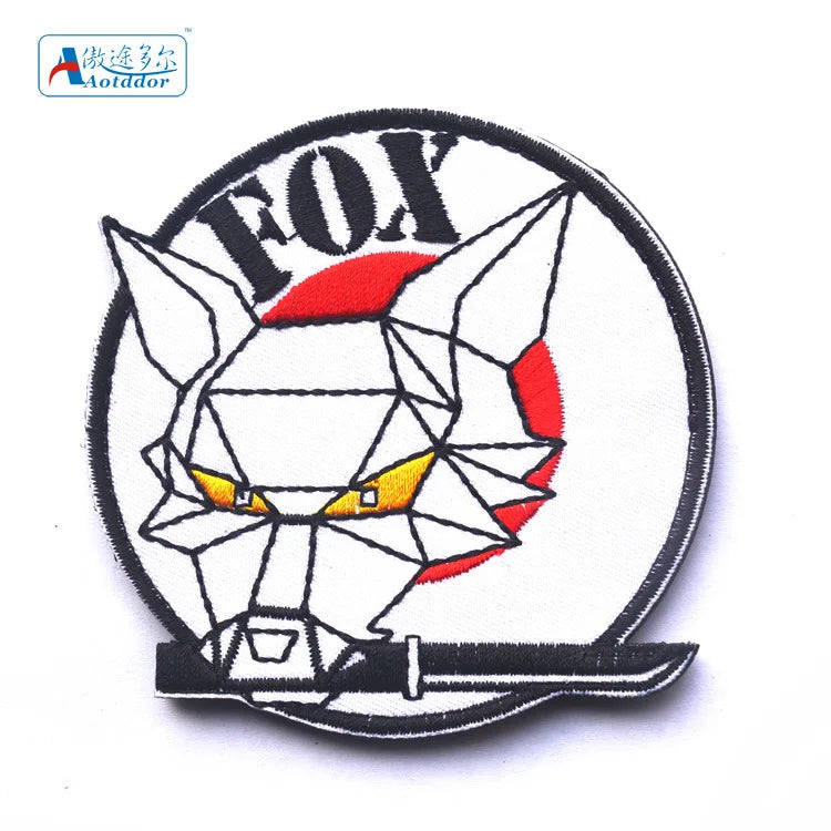 A embroidered patch featuring a stylized fox head design with red accents on a white background.