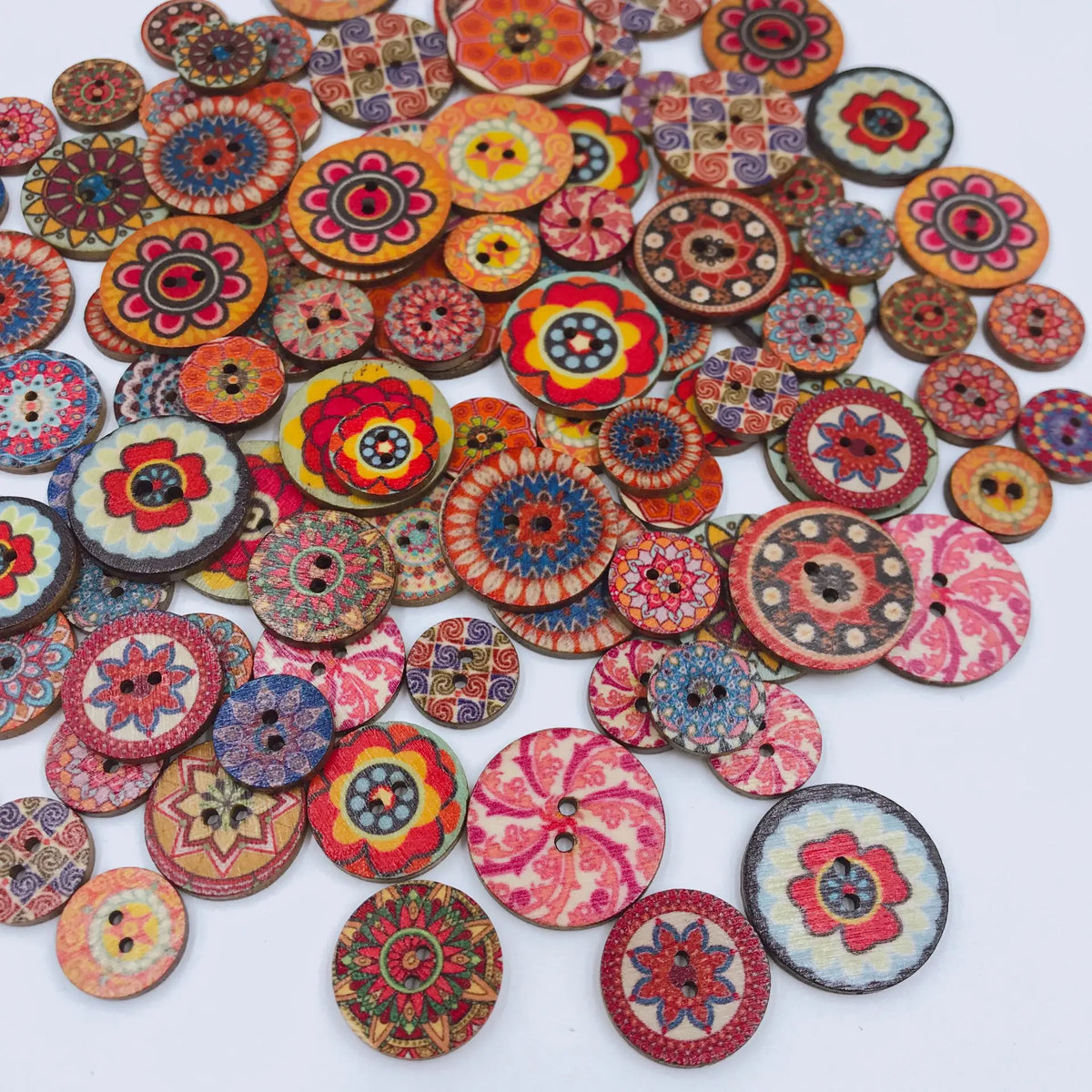 A collection of vintage wooden buttons in various colors and patterns arranged radially.