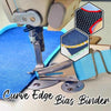 A close-up of a sewing machine pressing fabric with a binder used to secure the curve edge bias fabric.