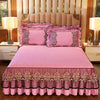 Pink quilted bed skirt set with matching pillowcases and a pink quilted bedspread.