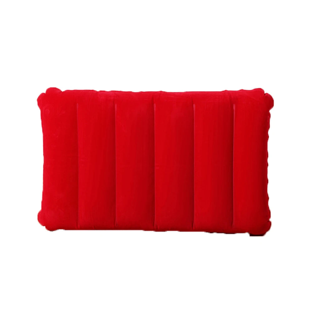 A bright red portable inflatable travel pillow with ribbed texture.