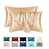 A set of satin silk pillow covers in various shades including gold, pink, green, red, black, blue, and white.