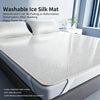 A white washable ice silk mat placed on a bed, emphasizing its smooth and cool texture.