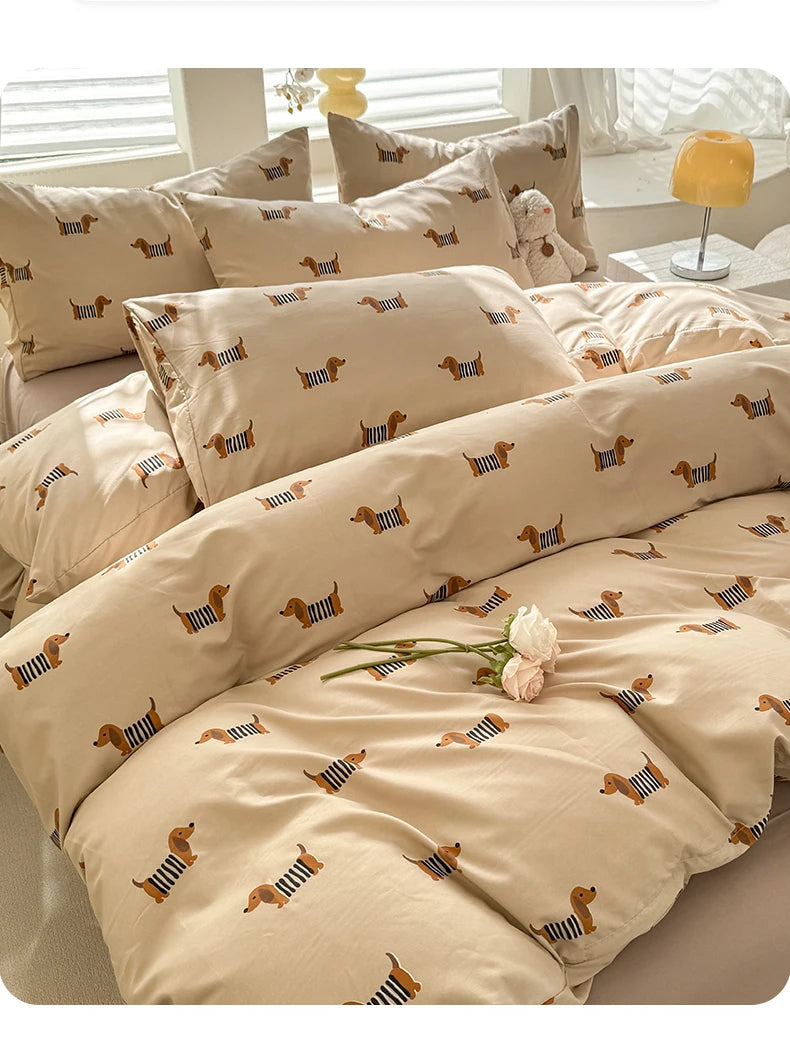 A beige duvet set featuring a repeating pattern of small brown and black dog silhouettes.