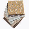 A stack of floral dot pattern cotton fabric squares in various earthy tones and textures.