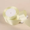 Roll of pale yellow satin craft ribbon with a white center core
