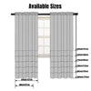 A set of light gray sheer voile curtains shown hanging in a window frame.