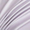 Soft lavender luxury bamboo flat sheets draped in flowing fabric