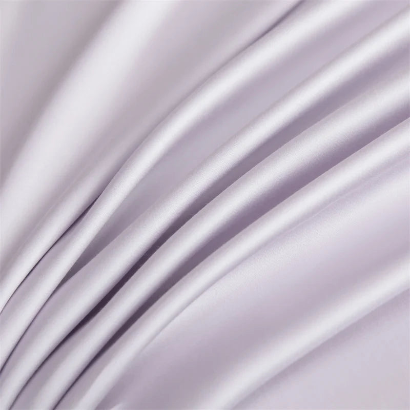 Soft lavender luxury bamboo flat sheets draped in flowing fabric