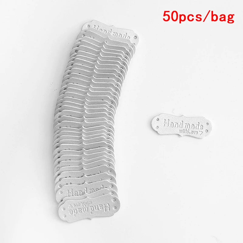A stack of 50 PU leather embossed tags for handmade crafting in a light gray color.