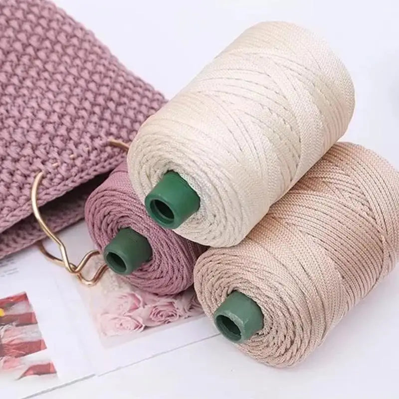 Spools of beige and mauve 3mm ice rope crochet yarn for crafting