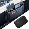 A black leather car organizer storage bag holding various electronic devices and cards.