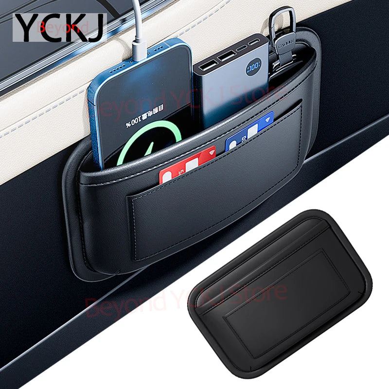 A black leather car organizer storage bag holding various electronic devices and cards.