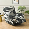 A modern armchair with a black and white geometric pattern sits on a light wood floor.