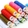 Rolls of brightly colored thread in various shades including pink, orange, yellow, and blue for sewing and embroidery