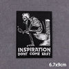 Black embroidered patch featuring a skeletal hand holding a toilet, with the text INSPIRATION DON'T COME EASY.