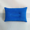 A bright blue portable inflatable travel neck pillow resting on a white surface.