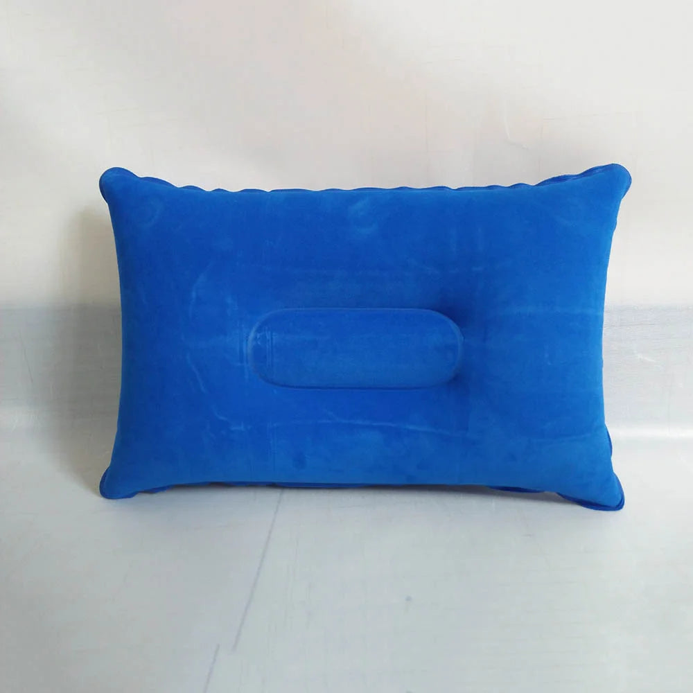 A bright blue portable inflatable travel neck pillow resting on a white surface.