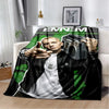 A black and white graphic throw blanket featuring a portrait of a man with green accents.