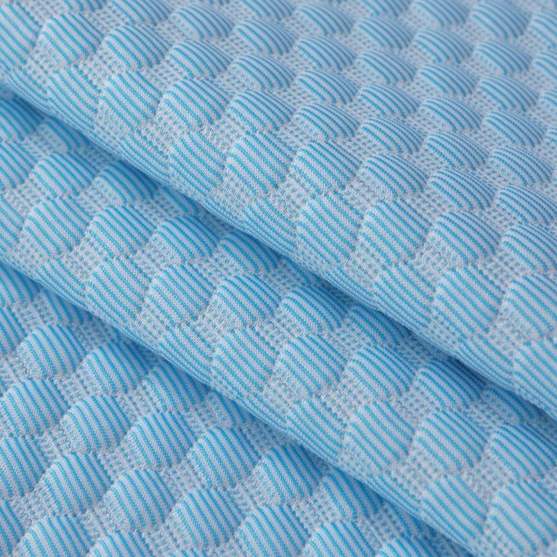 Light blue quilted fabric cover for a bean pillow, showing a diagonal fold.